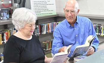 two people browsing the library