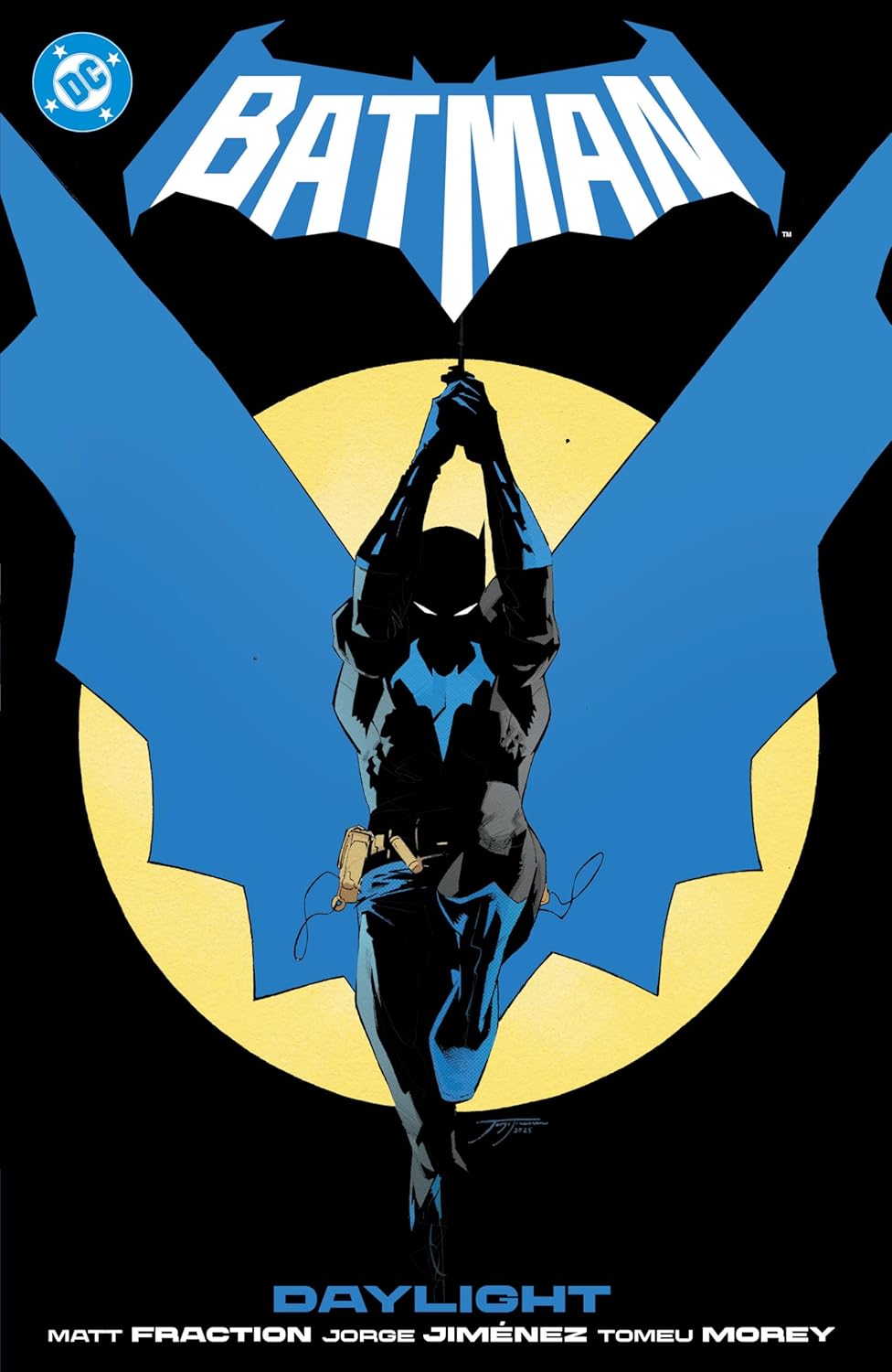 Graphic novel cover for "Batman Vol. 1: Daylight" written by Matt Fraction with art by Jorge Jiménez. The cover features a dynamic, high-energy illustration of Batman in his vibrant blue-and-grey costume, leaping over the stylized architectural rooftops of Gotham City, which is brightly illuminated by daylight. The iconic Batman bat-insignia is boldly incorporated into the design, with the title "Daylight" and the creators' names sharply displayed in clean, modern superhero typography.