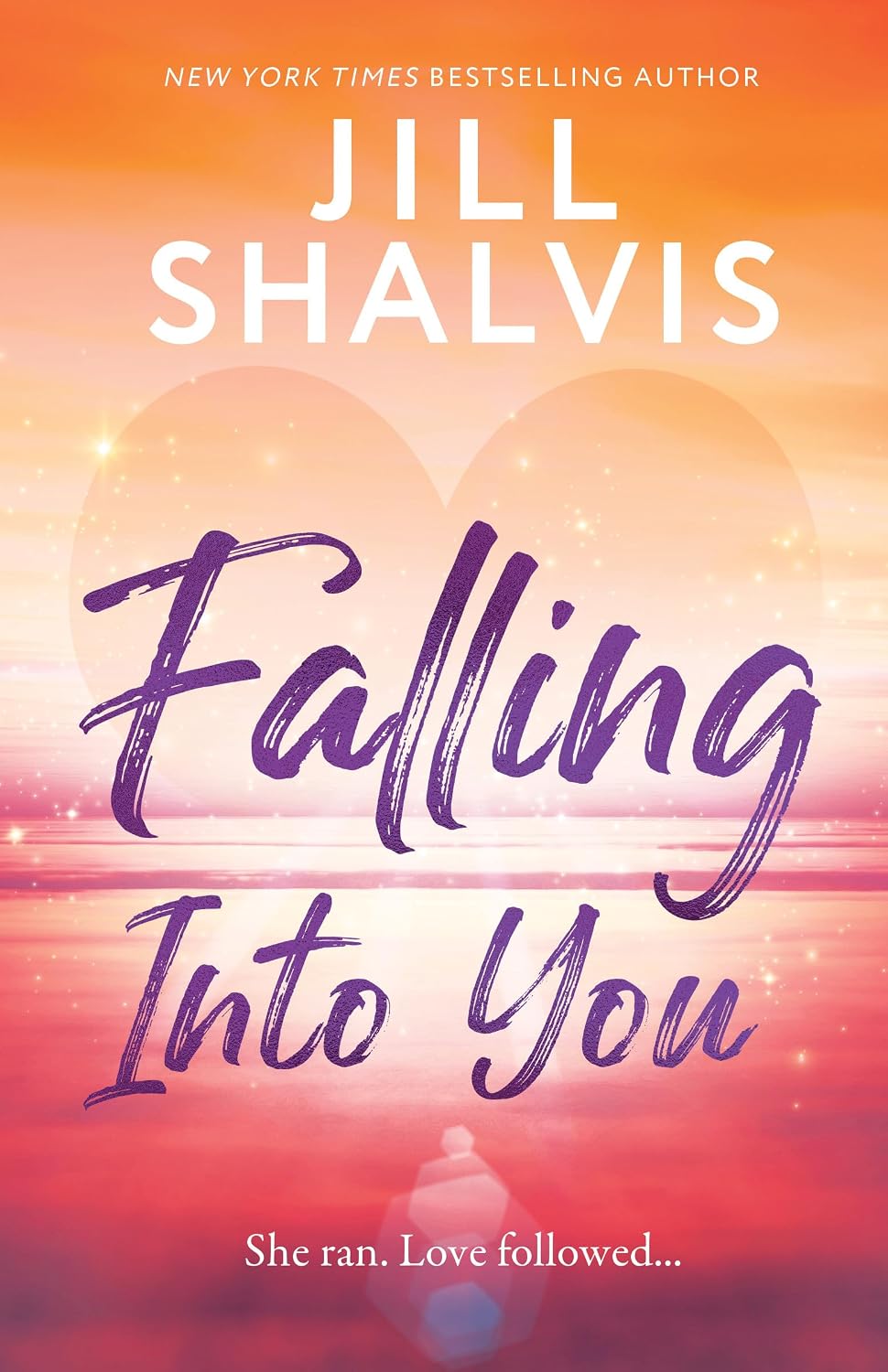 Cover of "Falling Into You" by Jill Shalvis. A faint sparkling heart glows over a pink-orange sunset, with the title in bold purple script and the tagline "She ran. Love followed..." below.
