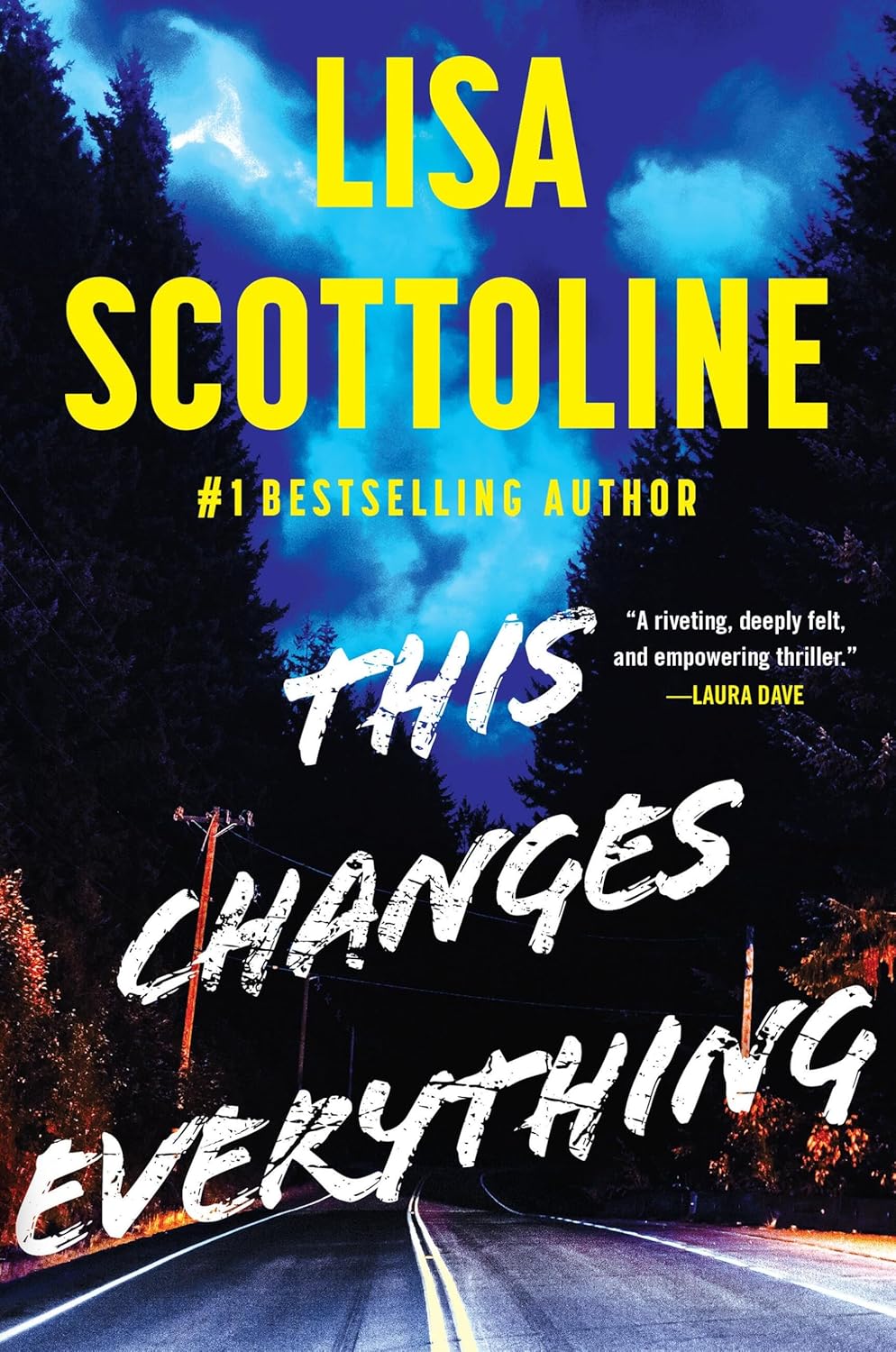 This Changes Everything" by Lisa Scottoline. A two-lane road winds through a dark forest at night under a cloudy blue sky, lit by a warm orange glow. The author's name is in bold yellow letters above the title, written in white brushstroke text. A blurb reads: "A riveting, deeply felt, and empowering thriller." —Laura Dave.